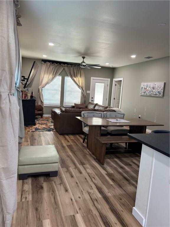 living room with wood finished floors, visible vents, baseboards, recessed lighting, and ceiling fan