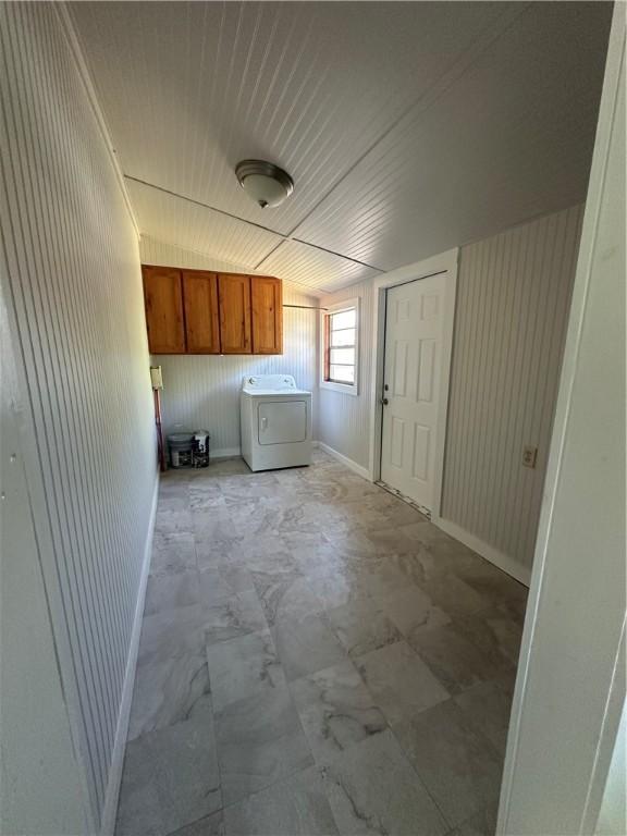 laundry area with washer / dryer, baseboards, and cabinet space