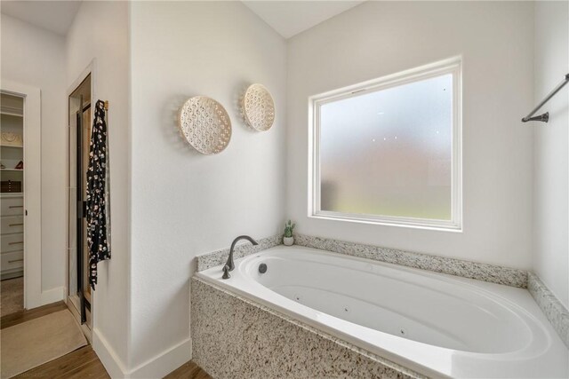 641 Hyacinth Dr, Corpus Christi, TX 78413 - full bathroom featuring a jetted tub, wood finished floors, and baseboards