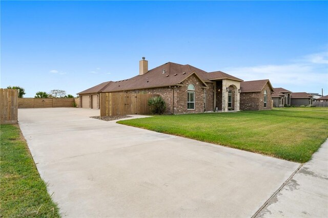 641 Hyacinth Dr, Corpus Christi, TX 78413 - view of front of property with brick siding, concrete driveway, and a chimney