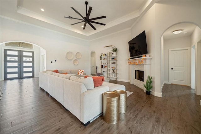 641 Hyacinth Dr, Corpus Christi, TX 78413 - living area with arched walkways, ceiling fan, a tray ceiling, wood finished floors, and crown molding