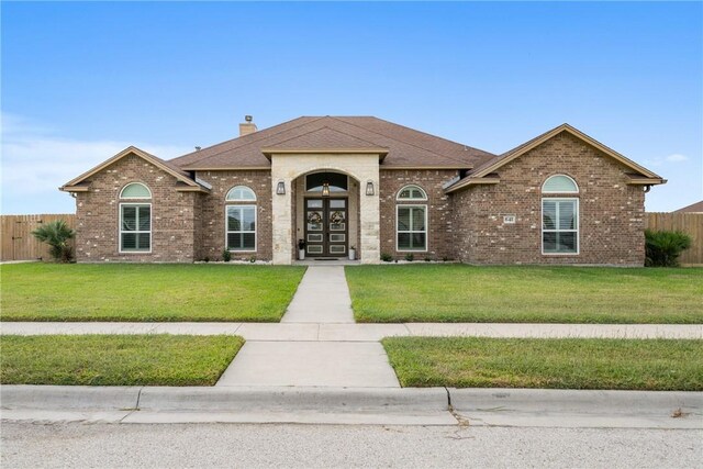 641 Hyacinth Dr, Corpus Christi, TX 78413 - view of front of property featuring brick siding, a chimney, roof with shingles, and french doors