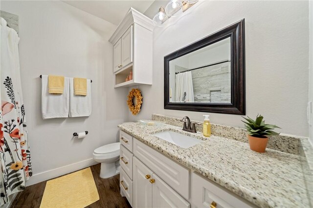 641 Hyacinth Dr, Corpus Christi, TX 78413 - bathroom with vanity, toilet, baseboards, wood finished floors, and curtained shower