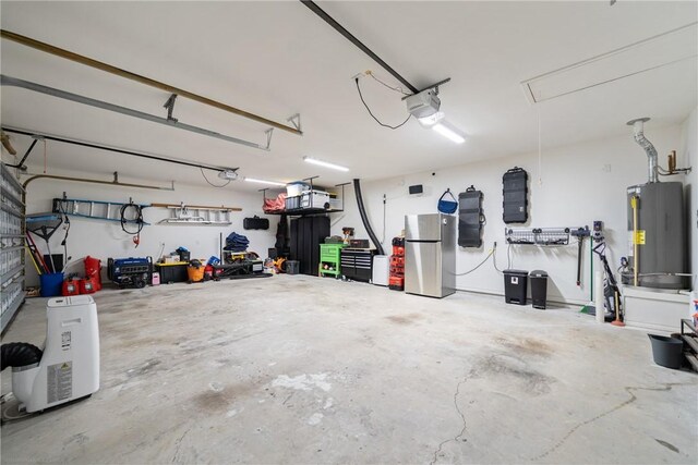 641 Hyacinth Dr, Corpus Christi, TX 78413 - garage featuring freestanding refrigerator, gas water heater, and a garage door opener