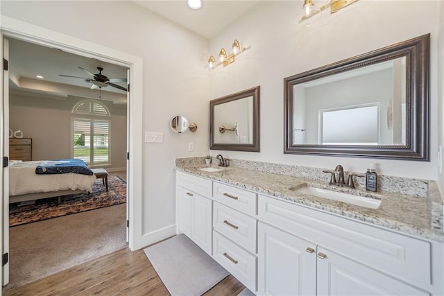 641 Hyacinth Dr, Corpus Christi, TX 78413 - bathroom featuring double vanity, wood finished floors, ensuite bathroom, ceiling fan, and baseboards