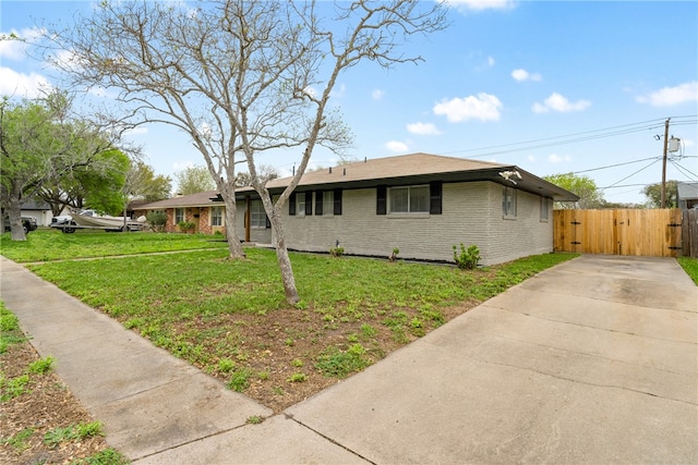 ranch-style home with a front lawn