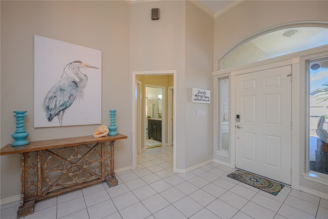 tiled foyer entrance with ornamental molding