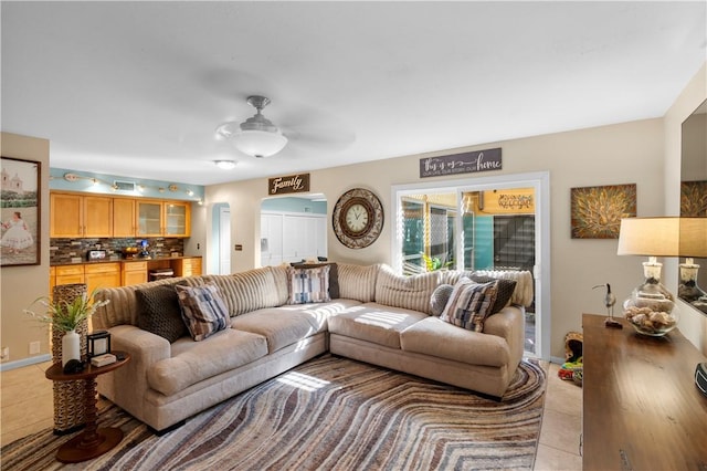 living room featuring ceiling fan and light tile patterned floors