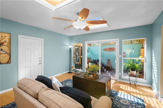 living room with ceiling fan and light hardwood / wood-style floors