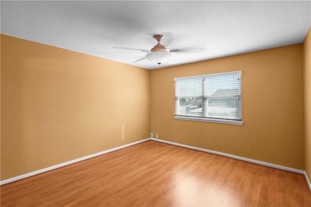 unfurnished room with hardwood / wood-style floors and ceiling fan