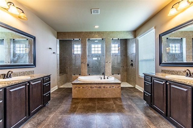 8054 Calgary Dr, Corpus Christi, TX 78414 - full bathroom featuring baseboards, two vanities, a walk in shower, a garden tub, and tile patterned floors