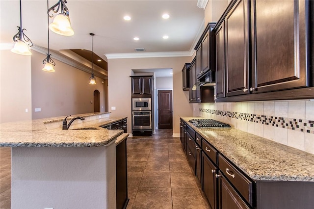 8054 Calgary Dr, Corpus Christi, TX 78414 - kitchen with appliances with stainless steel finishes, crown molding, a sink, tasteful backsplash, and dark brown cabinetry