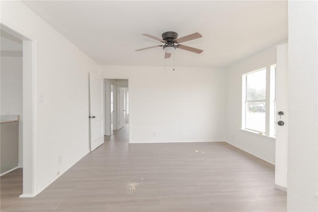 unfurnished room with ceiling fan and light hardwood / wood-style flooring