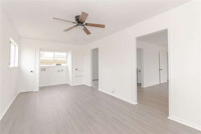 empty room with light hardwood / wood-style floors and ceiling fan