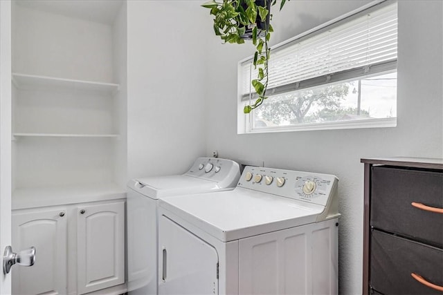 washroom featuring cabinets and independent washer and dryer