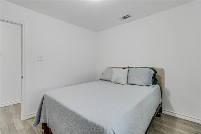 bedroom with wood-type flooring