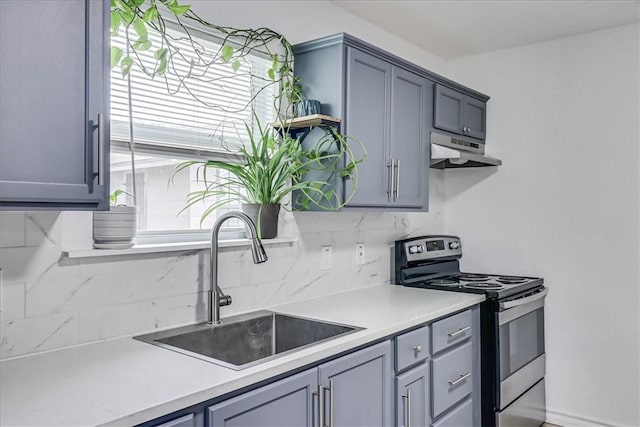 kitchen with sink, tasteful backsplash, gray cabinets, and stainless steel electric range