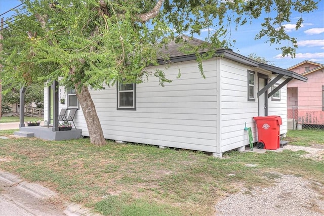 view of side of home with a lawn