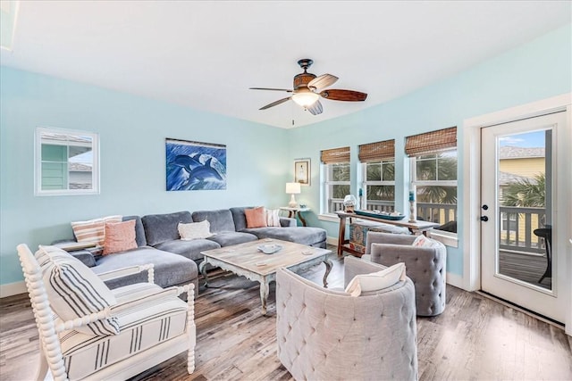 living room featuring light hardwood / wood-style flooring and ceiling fan