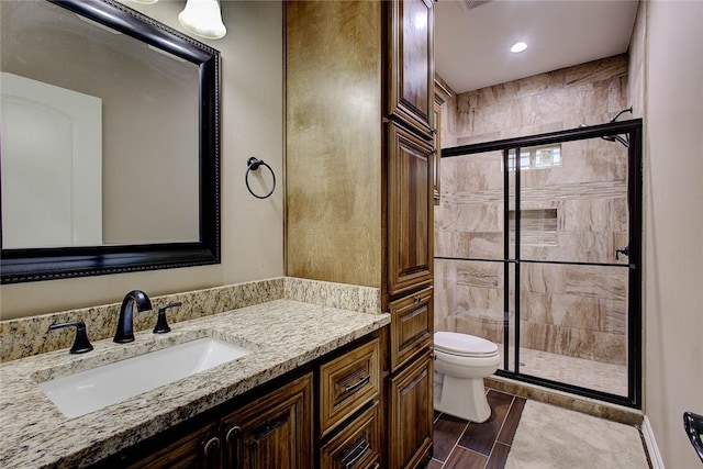 bathroom with vanity, toilet, and walk in shower