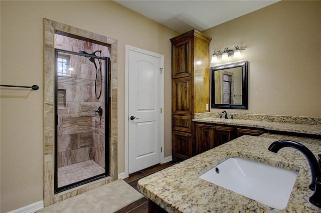 bathroom featuring vanity and a shower with door