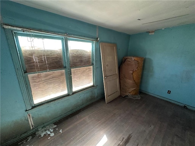 empty room with wood finished floors and a wealth of natural light