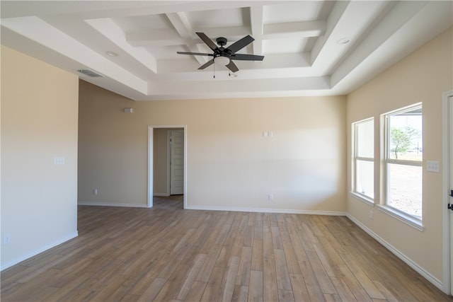 unfurnished room featuring beamed ceiling, ceiling fan, coffered ceiling, and light hardwood / wood-style flooring