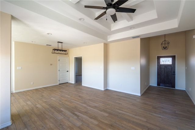 interior space featuring a tray ceiling, ceiling fan, and hardwood / wood-style floors