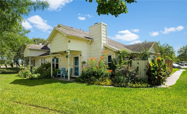 back of property with a lawn