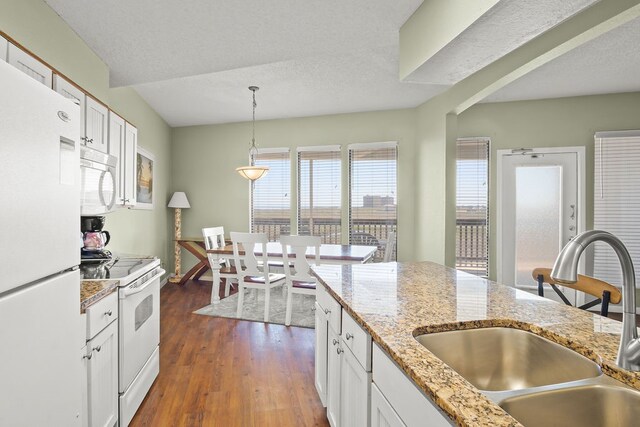 kitchen featuring white cabinetry, decorative light fixtures, dark hardwood / wood-style flooring, sink, and white appliances