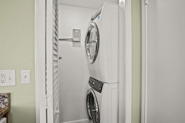 laundry room featuring stacked washer / dryer