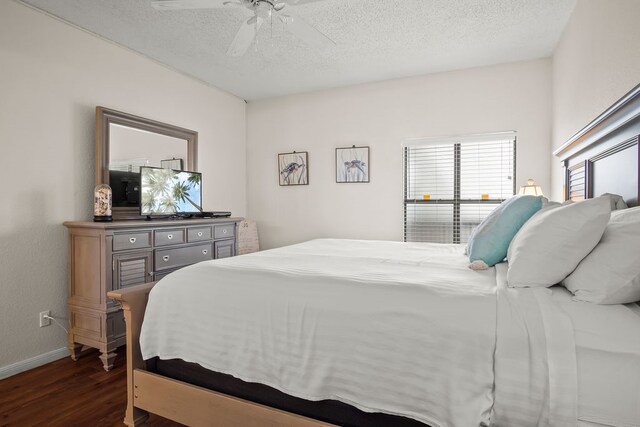 bedroom with ceiling fan, dark hardwood / wood-style floors, and a textured ceiling