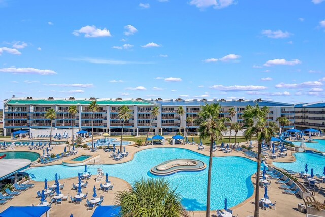 view of swimming pool with a patio and a jacuzzi