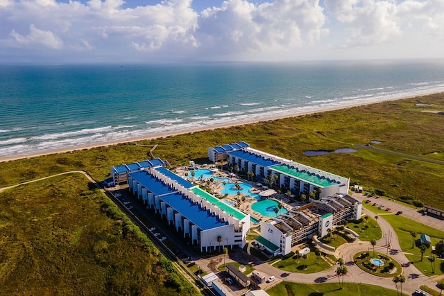 birds eye view of property with a water view and a beach view