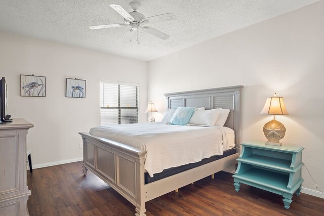 bedroom featuring a textured ceiling, dark wood-type flooring, and ceiling fan