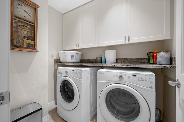 laundry room with cabinets and washer and dryer