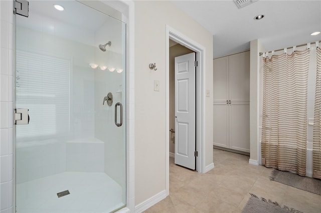 bathroom featuring tile patterned floors and a shower with shower door