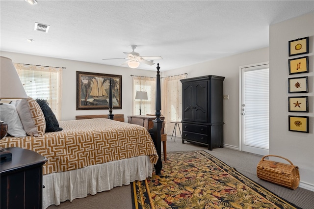 carpeted bedroom featuring a textured ceiling and ceiling fan