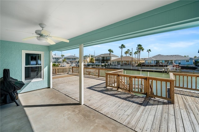 wooden terrace featuring a water view and ceiling fan