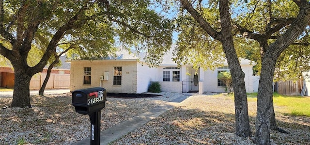 409 Fairway Oaks St, Rockport, TX 78382 - view of front facade with fence and brick siding