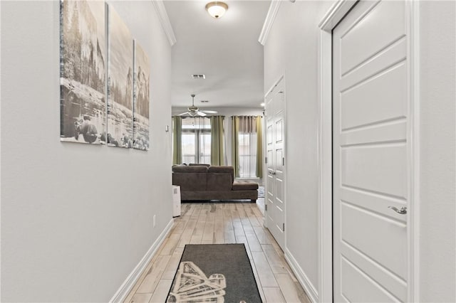 hall featuring ornamental molding and baseboards