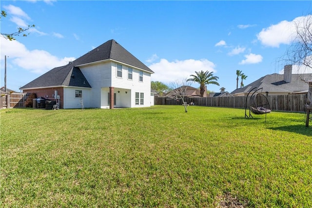 back of property featuring a yard and a fenced backyard