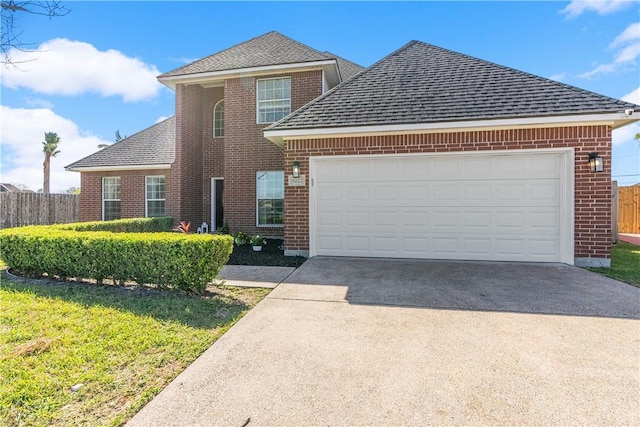 traditional home featuring brick siding, fence, roof with shingles, driveway, and an attached garage