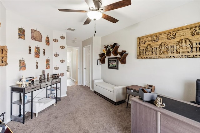 interior space featuring baseboards, carpet, visible vents, and ceiling fan