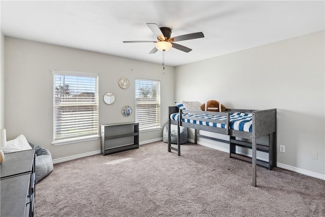 carpeted bedroom with baseboards and ceiling fan