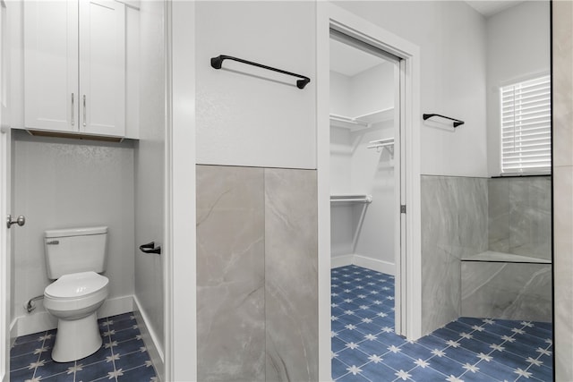 bathroom featuring walk in shower and toilet