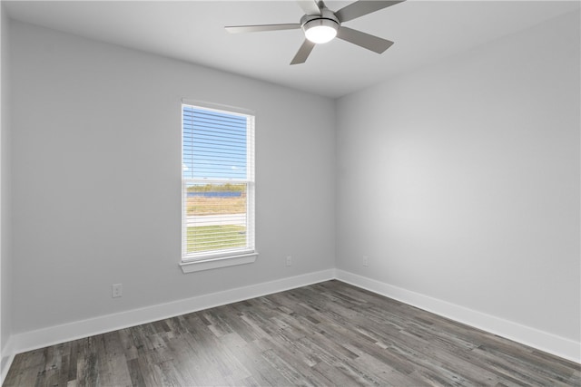 spare room with plenty of natural light, dark wood-type flooring, and ceiling fan