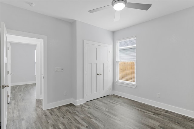 unfurnished bedroom with ceiling fan, a closet, and light hardwood / wood-style flooring