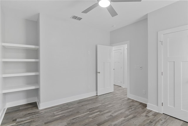 unfurnished bedroom with ceiling fan and light hardwood / wood-style flooring