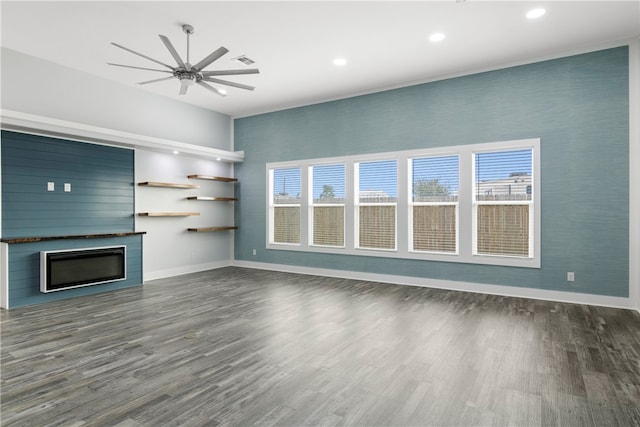 unfurnished living room with dark hardwood / wood-style floors, ceiling fan, and plenty of natural light